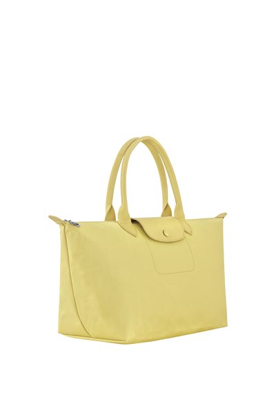Yellow rectangular tote bag with dual handles, a flap with snap button, and a zipper closure, shown against a white background.
