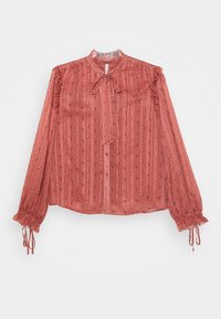 Blusa translúcida de color óxido con cuello atado, cierre de botones y mangas acampanadas, con rayas verticales y pequeños acentos decorativos.