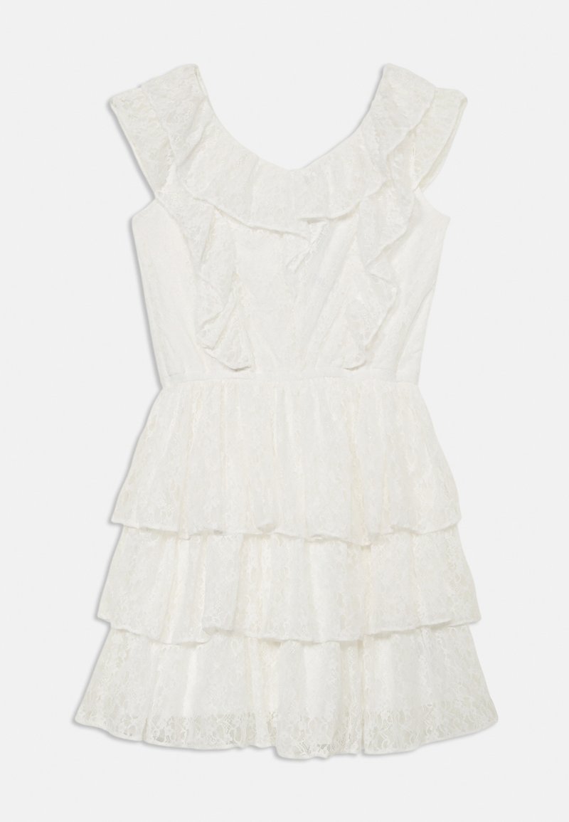Robe en dentelle blanche avec encolure à volants, design sans manches et jupe à étages. Présente une texture délicate et un voile transparent.