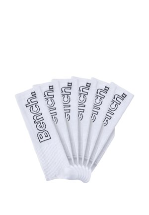 Seven pairs of white crew socks arranged fan-like, each with the black "Bench." logo knitted vertically near the top.
