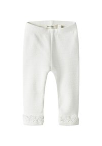 Witte katoenen legging met een gestructureerd patroon en kanten accenten aan de zoom. De tailleband is elastisch voor comfort en draaggemak.