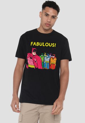 Young man wearing black T-shirt with colorful Batman figures in rainbow colors and the word "FABULOUS!" above them.