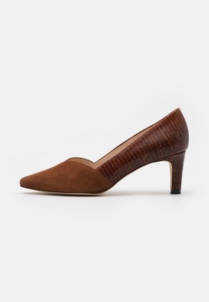 Escarpin marron pour femme à talon bas, bout pointu en daim et talon ainsi que côtés en cuir synthétique texturé sur fond blanc.