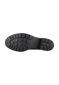 Suela de goma negra con una superficie texturizada, que presenta patrones hexagonales y profundas ranuras para ofrecer tracción y flexibilidad.