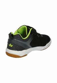 Black athletic shoe with mesh upper, green accents, and a white sole. Features a strap closure and textured rubber outsole.