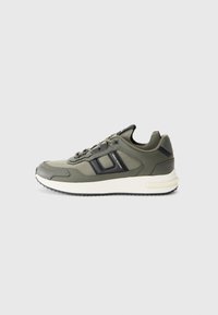 Olive green athletic shoe with black accents, textured synthetic upper, lace-up design, and white midsole with black outsole.