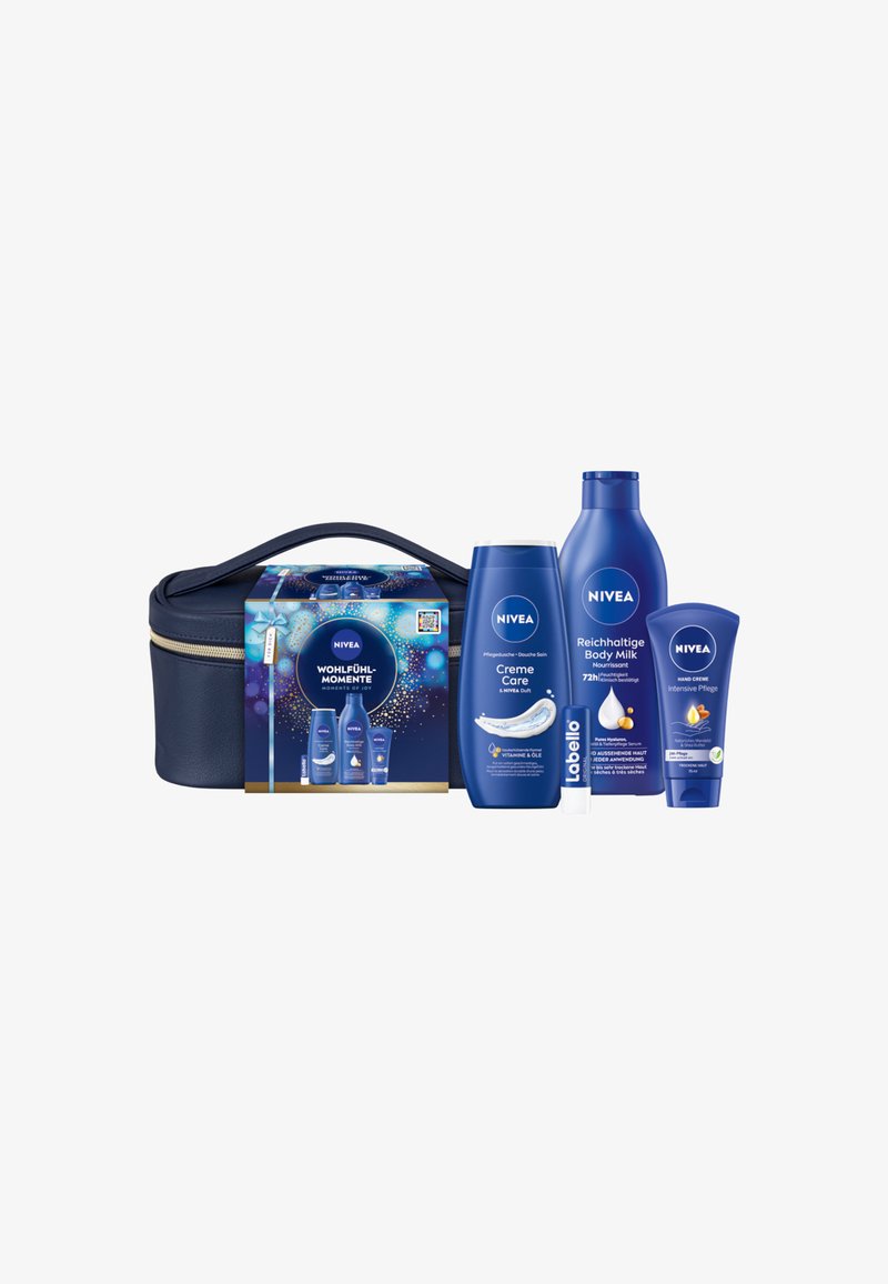 NIVEA skincare gift set with a navy zippered bag. Contains white and blue bottles: body milk, cream, and lip balm, featuring smooth textures.