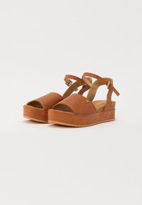 Brune plattform sandaler med teksturert lær overdel, åpne tær, ankelremmer og en solid gummisåle. Justerbar spenne.