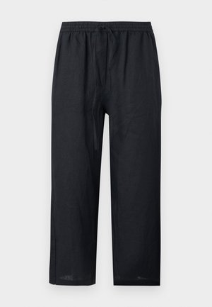 Svarte løstsittende linbukser med elastisk midjebånd og snor, rette ben, uten synlige lommer, vist på lys bakgrunn.