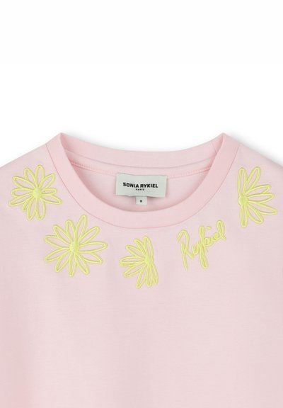 Pink cotton t-shirt featuring yellow embroidered daisies and "Rykiel" text near the neckline. Rounded collar design.