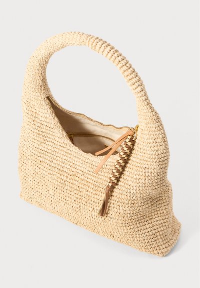 Beige woven straw handbag with a rounded handle, zipper closure, and a small braided accent on the zipper pull. Smooth inner lining.