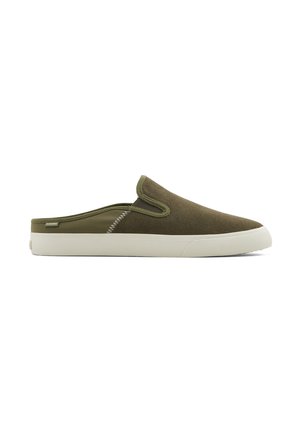 Olive green slip-on shoes with a soft, textured upper, white rubber sole, and contrasting stitching details along the side.