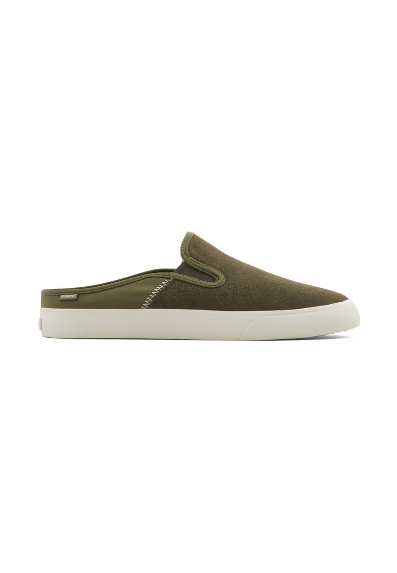 Olive green slip-on shoes with a soft, textured upper, white rubber sole, and contrasting stitching details along the side.