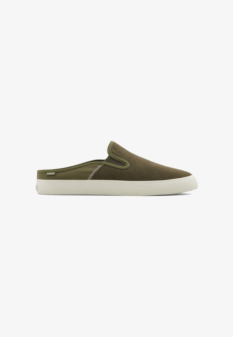 Olive green slip-on shoes with a soft, textured upper, white rubber sole, and contrasting stitching details along the side.