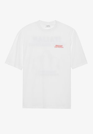 White cotton t-shirt with short sleeves, crew neck, and red text reading “ITALIAN WORST NIGHTMARE” on the left chest.