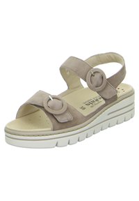 Sandali con zeppa in suede beige, dotati di due dettagli circolari, cinturino posteriore regolabile, soletta imbottita e suola in gomma per una buona aderenza.