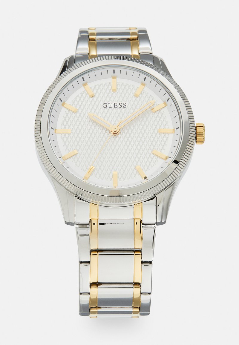 Silver and gold metal watch with a textured white dial, gold hour markers, and a date display. Features a link bracelet and screw-down crown.