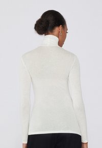Weißes Langarm-Turtleneck-Oberteil mit slim fit, leichtem, transparentem Material und geradem Saum. Keine zusätzlichen Verzierungen.