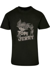 Black cotton T-shirt featuring a graphic print of cartoon characters Tom and Jerry, with the text "TOM and JERRY" in bold, distressed lettering.