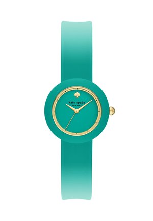 Turkis armbåndsur med gulddetaljer, rund urskive, minimale markeringer og teksten "kate spade NEW YORK" under et spar-logo.