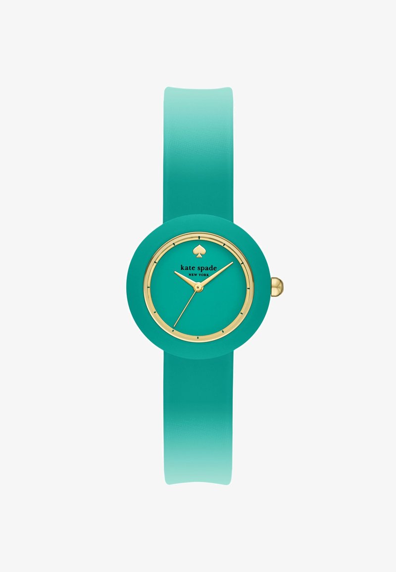 Turkis armbåndsur med gulddetaljer, rund urskive, minimale markeringer og teksten "kate spade NEW YORK" under et spar-logo.