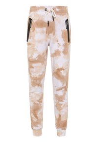 Tie-dye joggers in cream and beige, featuring a drawstring waistband, ribbed cuffs, and zippered side pockets with black accents.