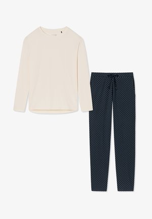 Long-sleeve cream top with round neckline paired with navy polka dot pants featuring a drawstring waistband. Both items made from soft fabric.