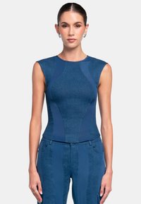 Sleeveless blue top with a fitted design, made of textured material, featuring curved panel accents in a darker shade.