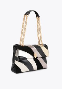Leather handbag with wavy black, white, silver, and gray stripes. Features a gold chain strap and a decorative clasp on the front.