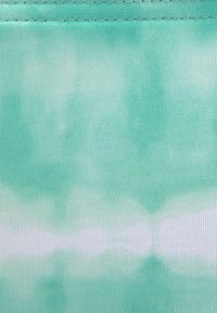 Svetlo zelena tkanina z vzorcem tie-dye, ki ima gladko teksturo in vertikalno rebro. Diskretni beli poudarki se brezhibno zlijejo.