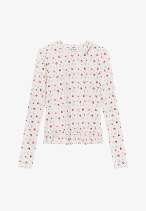 Chemise blanche à manches longues avec motif de baies rouges, bleues et grises, ourlet à volants et logo "Oh April" près de l'encolure ronde.