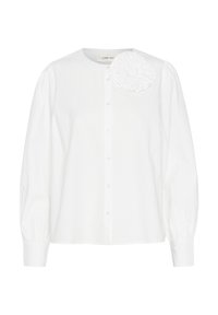 Hvid skjorte med lange ærmer, der har en rynket blomstret accent på venstre skulder. Fremstillet af glat stof med klassisk krave.