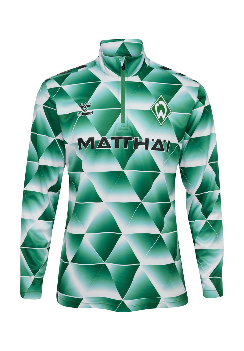 Grön långärmad sportströja med zipkrage. Har ett geometriskt diamantsmönster i varierande nyanser av grönt och vitt. Logotyper från varumärken ingår.