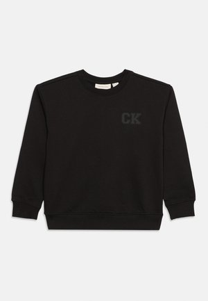 Melns garām piedurknēm džemperis ar apaļu kaklu, ar rievotām aprocēm un apakšu, uz kreisās krūtis ir neliels "CK" logotips.