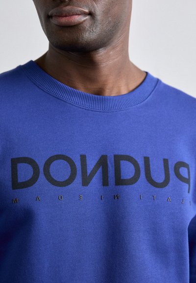 Blue sweatshirt featuring a ribbed neckline, large black lettering spelling "DONDU," with a smooth, soft texture and minimalist design.