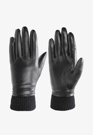 Schwarze Lederhandschuhe mit weicher Textur, ausgestattet mit gerippten schwarzen Strickbündchen und einem eleganten Design, geeignet für kaltes Wetter.