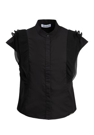 Black blouse featuring a high collar, button closure, and ruffled mesh accents on the shoulders, crafted from a smooth fabric.