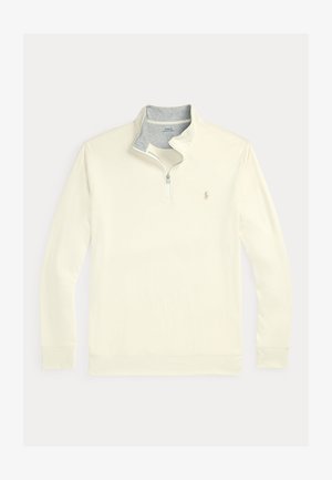 Pull-over crème avec une fermeture éclair quart de longueur et un col intérieur gris. Comprend des manches longues et un petit logo sur la poitrine gauche. Texture lisse.
