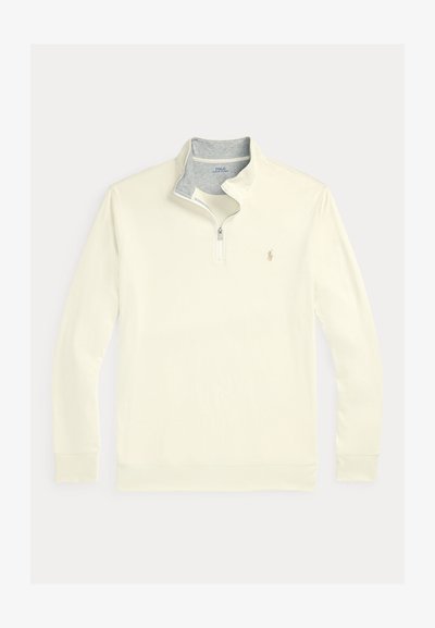 Pull-over crème avec une fermeture éclair quart de longueur et un col intérieur gris. Comprend des manches longues et un petit logo sur la poitrine gauche. Texture lisse.