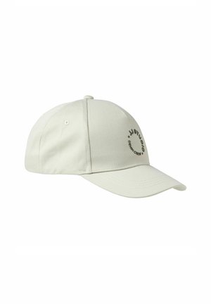 Light beige baseball cap made of fabric with a curved brim, featuring a black circular logo and text on the front panel.