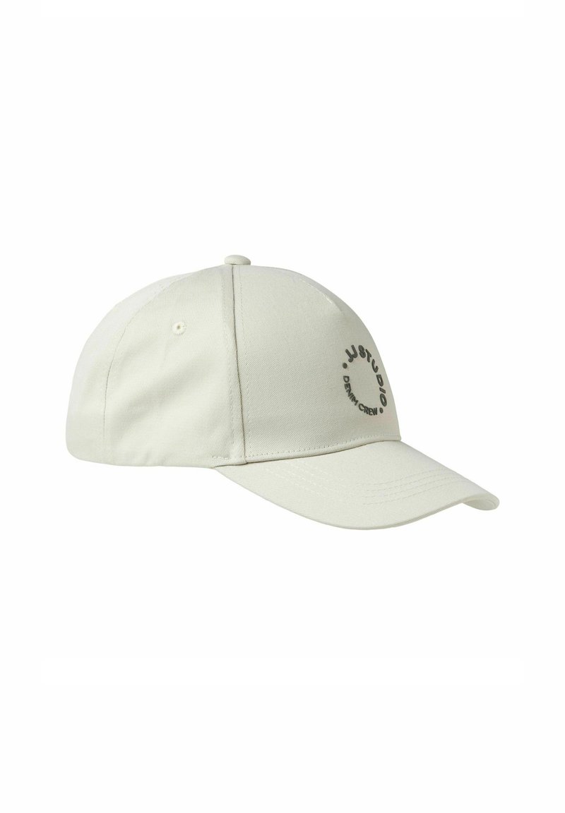 Light beige baseball cap made of fabric with a curved brim, featuring a black circular logo and text on the front panel.