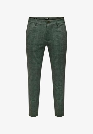 Zaļas bārkstainas bikses ar šauru piegriezumu. Izgatavotas no strukturēta auduma, ar rāvējslēdzēju, pogu aizdari un priekšējām kabatām.