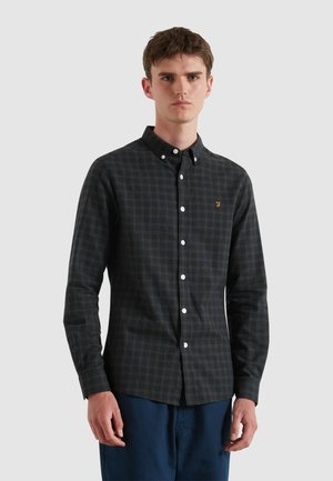 Men's dark green plaid button-down shirt with long sleeves, white buttons, and an embroidered logo on the chest. Cotton fabric.