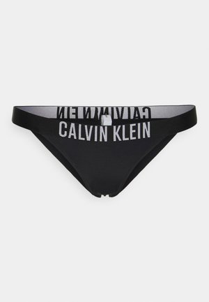 Juodas bikini kelnaitės su lygiu paviršiumi, pasižyminčios plačiu juosmeniu su "CALVIN KLEIN" logotipu baltos spalvos. Minimalistinis dizainas ir žemas kirpimas.