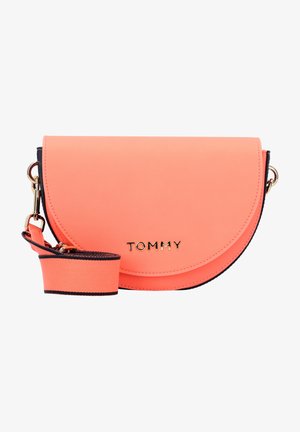 Coral leather crossbody bag with gold hardware, oval shape, textured surface, and an adjustable strap featuring a contrasting navy stripe.