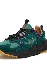Sneaker in suede verde con tomaia in rete testurizzata, dotate di lacci e dettagli viola, e suola in gomma nera maculata.