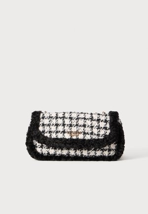 Sort og hvid hundetandsmønstret clutch med sort pelskant og gyldent Guess-logo på frontklappen.