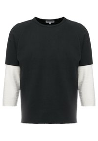 Schwarzes und weißes Raglan-Ärmeloberteil mit strukturierter Oberfläche; schwarzer Körper und weiße Ärmel. Runder Ausschnitt, lockerer Schnitt, weicher Stoff.