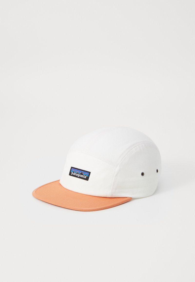 White cotton cap with an orange visor, featuring a Patagonia logo patch in blue and black on the front panel. Two ventilation eyelets visible.