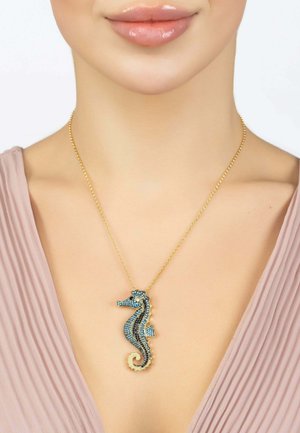Gold chain necklace featuring a blue and black encrusted seahorse pendant with intricate detailing and a swirled tail design.